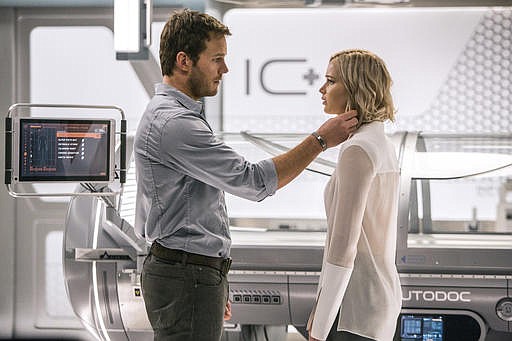 This image released by Columbia Pictures, Chris Pratt, left, and Jennifer Lawrence in a scene from the film, Passengers." 