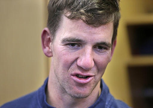 New York Giants quarterback Eli Manning talks to a reporter in the locker room after football practice in East Rutherford, N.J., Thursday, Jan. 5, 2017. 