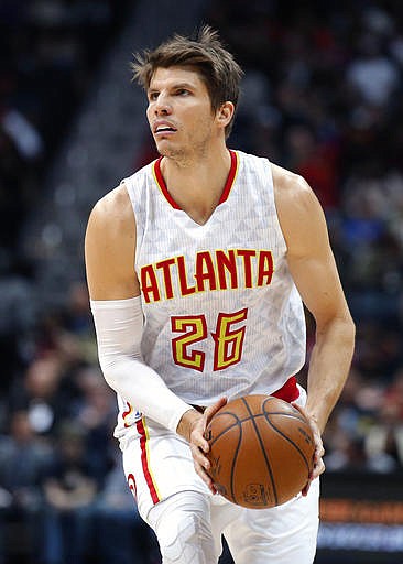 In this Friday, Dec. 30, 2016, file photo,Atlanta Hawks guard Kyle Korver (26) sets up a shot in the first half of an NBA basketball game against the Detroit Pistons in Atlanta. Korver has officially joined the Cleveland Cavaliers, who acquired one of the NBA's best 3-point shooters in a trade from Atlanta. 