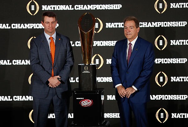 Clemson coach Dabo Swinney and Alabama coach Nick Saban pose Sunday with the championship trophy in Tampa, Fla.