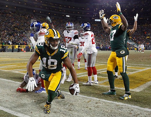 Packers wide receiver Randall Cobb celebrates after making a touchdown reception as time expired in the first half of Sunday's game against the Giants in Green Bay, Wis.