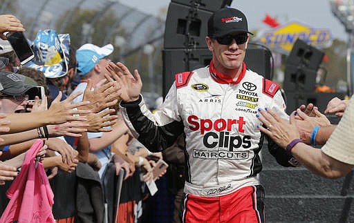  In this Oct. 30, 2016, file photo, Sprint Cup Series driver Carl Edwards (19) greets fans during driver introductions for the NASCAR Sprint Cup auto race at Martinsville Speedway in Martinsville, Va. 