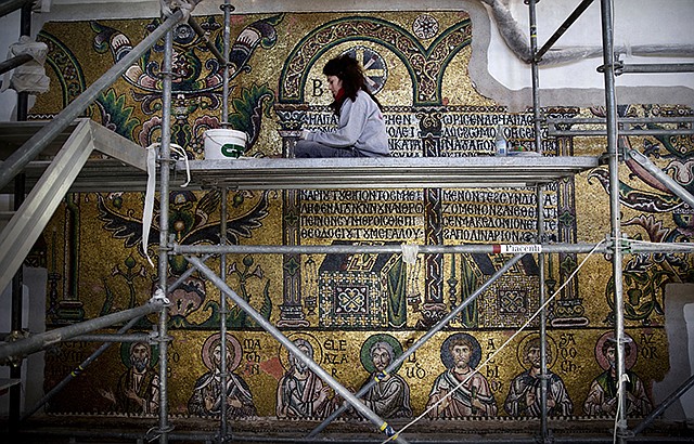 A restoration expert works on a mosaic February 2016 inside the Church of the Nativity in the West Bank city of Bethlehem. The Italian firm restoring one of Christianity's holiest sites — the Church of the Nativity in Bethlehem — said it's more than halfway finished with the project, which has already uncovered a Crusades-era mosaic angel hidden under plaster. Piacenti SpA, a family-run conservation firm from the Tuscan town of Prato, won the contract to restore the biblical place of Jesus' birth and began work in 2013 alongside Palestinian workers.