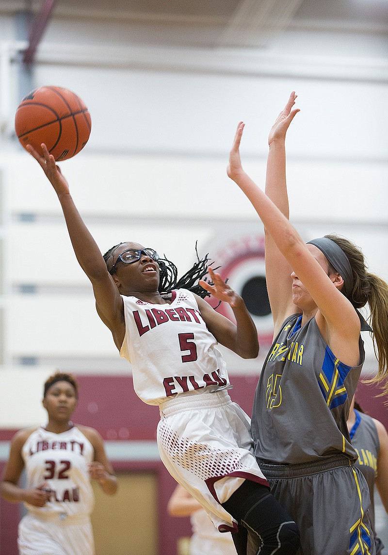 Liberty-Eylau's Elijah Howard leans back to get off her shot against North Lamar's Summer Andrews on Tuesday at the Rader Dome in Texarkana, Texas.