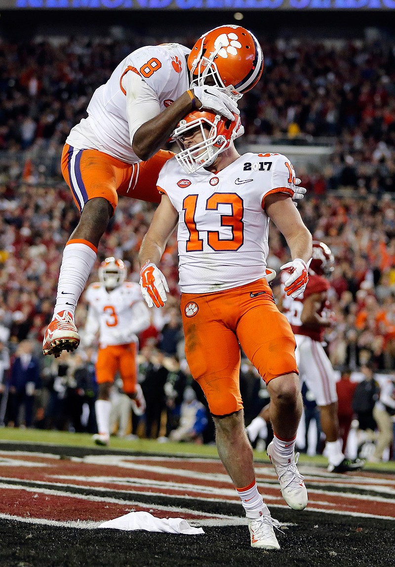 Clemson's Hunter Renfrow is congratulated by teammate Deon Cain after catching a touchdown pass during the second half of the NCAA college football playoff championship game against Alabama Monday, Jan. 9, 2017, in Tampa, Fla. 