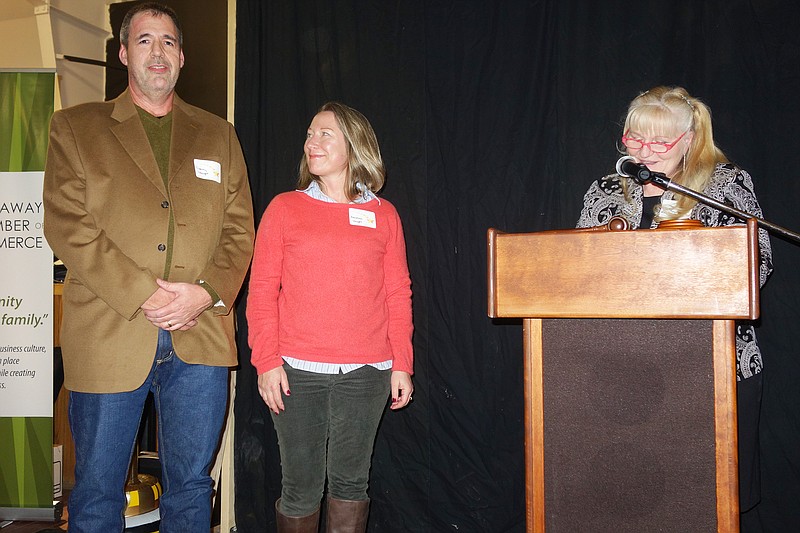 Garry, left, and Rebekah Vaught, center, received the evening's highest honor, the JH Atkinson Award; Marty Martin-Forman, right, announced.