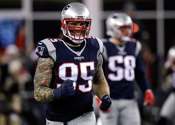 Patriots defensive end Chris Long reacts during the first half of a game last month in Foxborough, Mass. This weekend will mark the first playoff appearances for a handful of New England newcomers, including Long, who have had an impact for the Patriots this season.