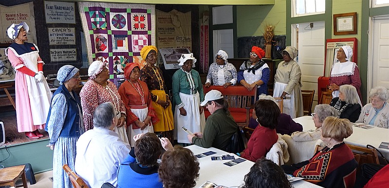 The Pleasant Hill Quilters are, from left, Ether Blaylock, LaWanda Warren, Alvis Dorsey, LaJoyce Flanagan, Volena Allen, Genell Jackson, Oteria McDaniel, Vance Gaines and Audrie Caldwell. Flo Stevenson, upper left, is introducing them. Members not present this day were Joyce Norman, Eunice Pruitt, Vernelle Richardson and Mary Shurn.