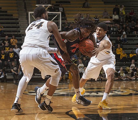 Auburn's T.J. Dunans fights his way between Missouri's Kevin Puryear (left) and Jordan Barnett during the second half of Tuesday's game at Mizzou Arena.