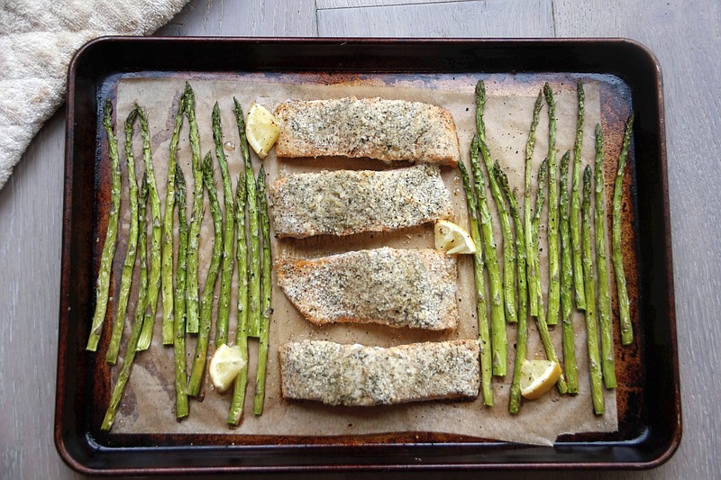 This Jan. 2, 2017 photo shows a sheet-pan supper of salmon and asparagus in Coronado, Calif., a recipe by Melissa d'Arabian. 