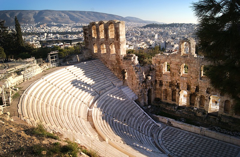 In this Dec. 11, 2016 photo, the Odeon of Herodes Atticus, or Herodeon, a stone theatre structure located on the southwest slope of the Acropolis of Athens, is seen against a backdrop of Athens. For travelers with more than beaches on their minds, there's plenty of upside to a brief winter visit to Athens that avoids the crowds and heat of summer. 