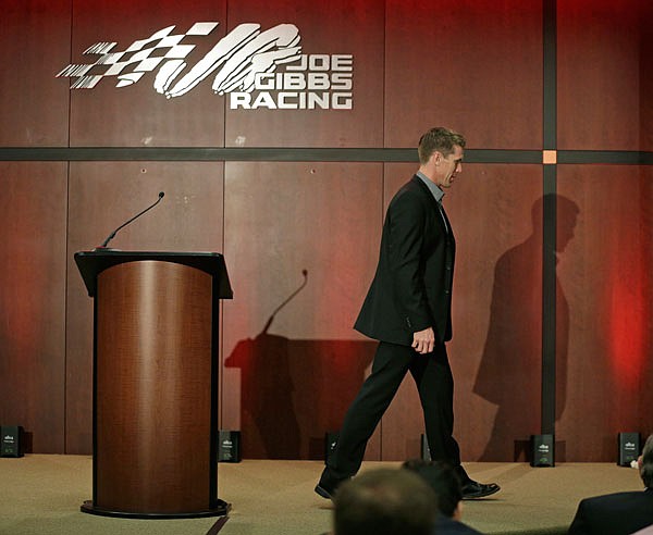 Carl Edwards leaves the stage after speaking to the media during a news conference Wednesday at Joe Gibbs Racing in Huntersville, N.C. Edwards, a Columbia native, announced he is stepping away from racing.