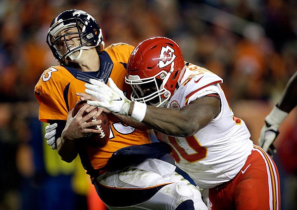 Chiefs outside linebacker Justin Houston sacks Broncos quarterback Trevor Siemian in the end zone for a safety during a game earlier this season in Denver. The Chiefs are hopeful Houston will play in Sunday's divisional playoff game against the Steelers.
