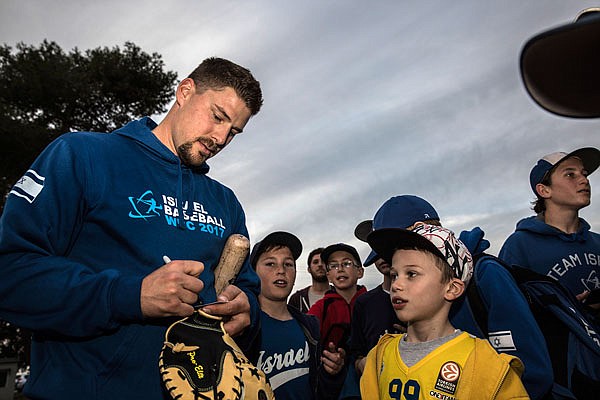 In this Jan. 5 file photo, Ryan Lavarnway, an American professional baseball player, signs autographs for Israeli fans before practice at the Baptist Village sport complex near Petah Tikva, Israel. Israel has emerged as a potential spoiler in the upcoming World Baseball Classic since it can have American pro players of Jewish descent join the team.