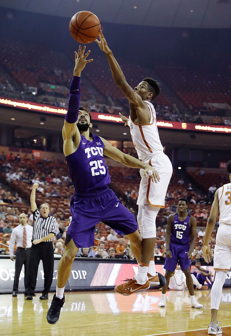 TCU guard Alex Robinson (25) is fouled by Texas guard Kerwin Roach Jr. (12) as he shoots during the first half of an NCAA college basketball game, Wednesday, Jan. 11, 2017, in Austin, Texas.