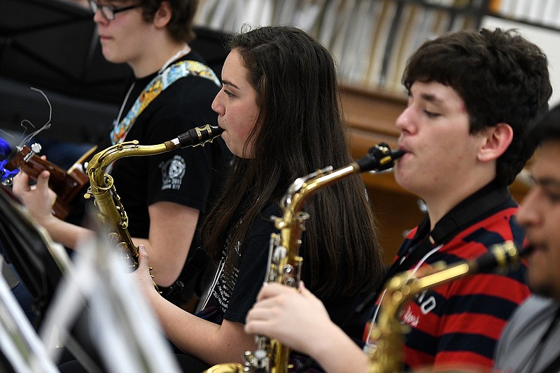 Texas High tenor saxophone player Michelle Moser, left, practices with the jazz band on Thursday at the Four States Bandmasters Convention & Clinic at Texas High School. 