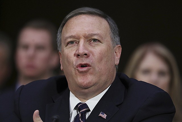 CIA Director-designate Rep. Michael Pompeo, R-Kan., testifies Thursday on Capitol Hill in Washington at his confirmation hearing before the Senate Intelligence Committee. Seated behind Pompeo is his wife Susan Pompeo, right, and their son Nick, left.