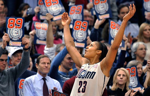 In this Dec. 21, 2010, file photo, Connecticut forward Maya Moore celebrates near the end of the team's game against Florida State in Hartford, Conn. Connecticut won 93-62 to to set an NCAA record for consecutive wins, at 89. Moore, who was instrumental in the previous 90-game winning streak, hopes the current team can keep their current run going.