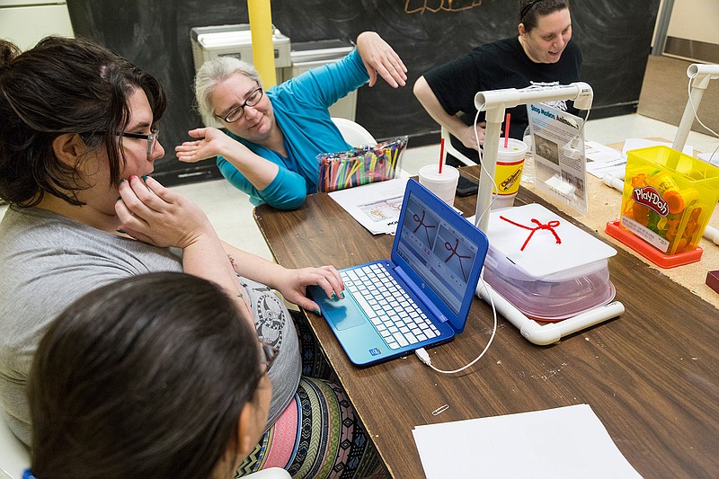 Jamie Simmons, curator of the Texarkana Museums System,  motions with her hands how she wants the pipe-cleaner animation to move Friday. Jan. 13, 2017, at Discovery Place Interactive Museum. Workers at Discovery Place learned how to assemble and operate a stop-motion animation studio on loan from The Arkansas Discovery Network. 