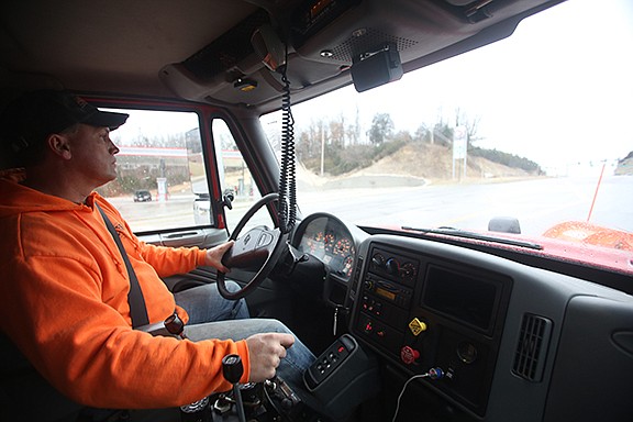 Eric Dulle drives along his route during the beginning of winter storm Jupiter in Jefferson City on Friday. Dulle works for the Street Division of Jefferson City to ensure that streets remain as safe as possible during inclement weather. Dulle said shifts can last as long as 12 hours with drivers circling routes multiple times.