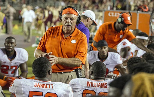 Int his Sept. 20, 2014, file photo, Clemson defensive tackles coach Dan Brooks talks to his players in the second half of an NCAA college football game against Florida State in Tallahassee, Fla. Brooks is retiring after eight seasons with the Tigers.