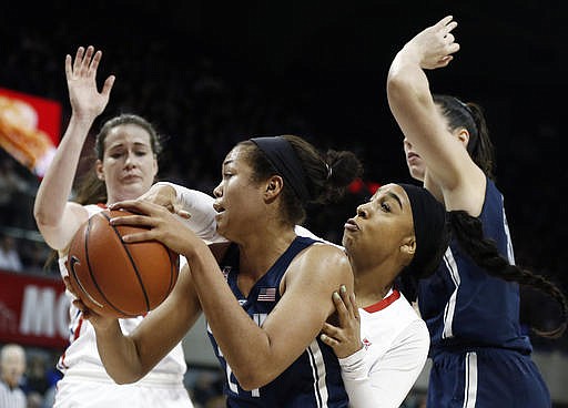 Connecticut forward Napheesa Collier, center, battles SMU guard Devri Owens, second from right, during the first half of an NCAA college basketball game, Saturday, Jan. 14, 2017, in Dallas. 