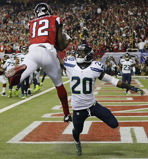 Atlanta Falcons wide receiver Mohamed Sanu (12) makes a touchdown catch against Seattle Seahawks cornerback Jeremy Lane (20) during the second half of an NFL football divisional football game, Saturday, Jan. 14, 2017, in Atlanta.