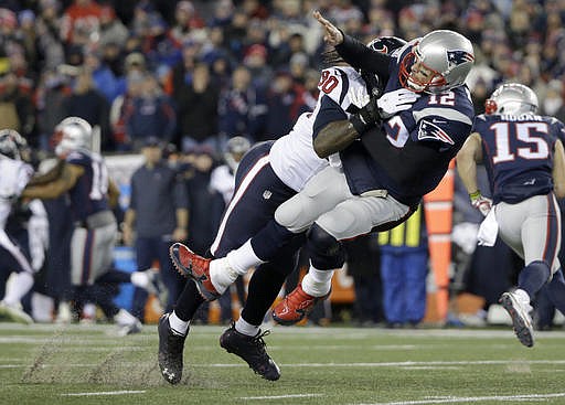 Houston Texans defensive end Jadeveon Clowney (90) levels New England Patriots quarterback Tom Brady (12) after Brady released a pass during the first half of an NFL divisional playoff football game, Saturday, Jan. 14, 2017, in Foxborough, Mass. (AP Photo/Elise Amendola)