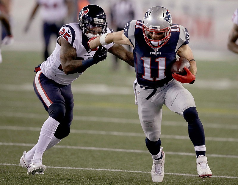 New England Patriots wide receiver Julian Edelman (11) tries to shake free from Houston Texans cornerback Kareem Jackson (25) after catching a pass during the first half of an NFL divisional playoff football game, Saturday, Jan. 14, 2017, in Foxborough, Mass.