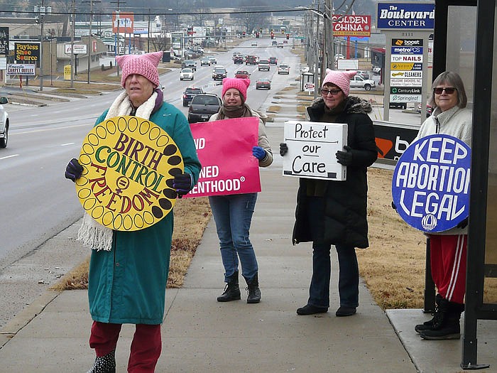 Four women stage a protest Sunday near Congressman Blaine Lutkemeyer's Jefferson Ctiy office.