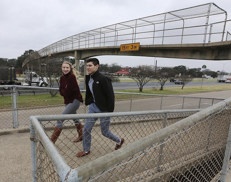 In this Thursday, Jan. 5, 2017, photo, Dustin Flores, right, and Hannah Foster walk across a pedestrian bridge that connects the Baylor campus with West Campus Lofts in Waco, Texas. The bridge will go away with the expansion project, cutting off an increasingly busy pedestrian connection between Baylor and the new cluster of restaurants and student housing on the other side of the interstate.