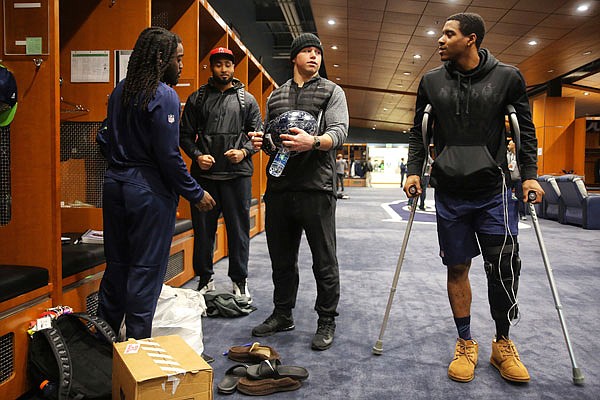 From left, Seahawks running back Alex Collins, linebacker K.J. Wright, linebacker Brock Coyle and cornerback DeShawn Shead chat as players clean out their lockers Sunday at the Virginia Mason Athletic Center in Renton, Wash.