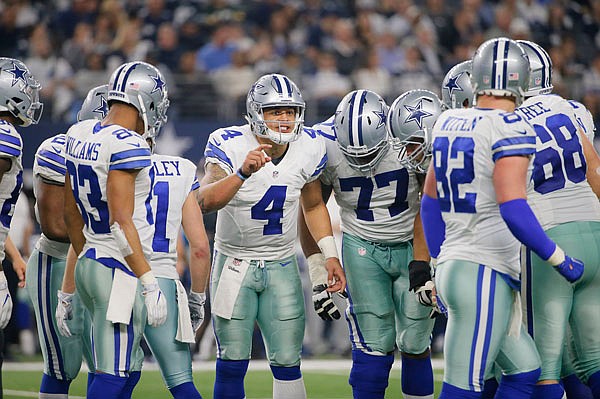 Cowboys quarterback Dak Prescott huddles with his offense during the second half of Sunday's game against the Packers in Arlington, Texas.