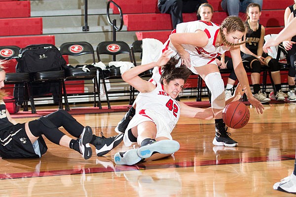 Micah Linthacum (left) of the Lady Jays falls to the floor as Greta Haarmann tries to grab a loose ball during Monday's game against Lebanon at Fleming Fieldhouse.