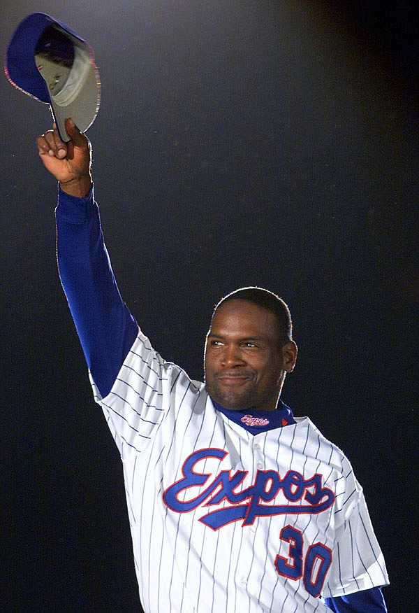 In this April 6, 2001, file photo, Tim Raines acknowledges applause from fans as he is presented before the Expos home opener in Montreal.