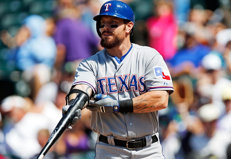 In this July 22, 2015, file photo, Texas Rangers' Josh Hamilton gets set to bat against the Colorado Rockies during a baseball game in Denver. Hamilton, the 2010 AL MVP who has had surgery three times on his left knee since last playing in 2015, knows he has to earn a spot on the Rangers' roster this spring. The five-time All-Star outfielder will also be learning a new position. 