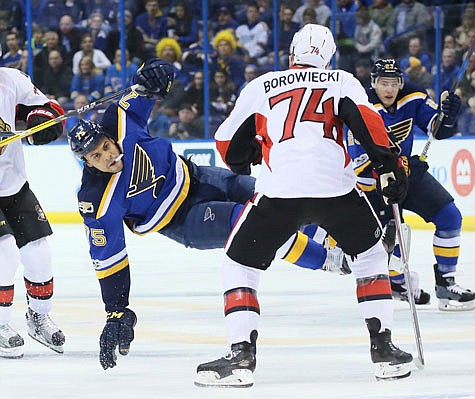 Ryan Reaves of the Blues is upended as he collides with Mark Borowiecki of the Senators during Tuesday night's game in St. Louis.