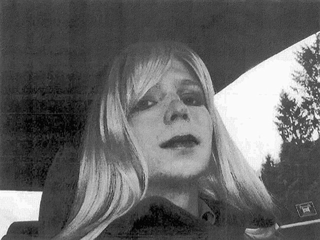 Pfc. Chelsea Manning poses for a photo wearing a wig and lipstick.