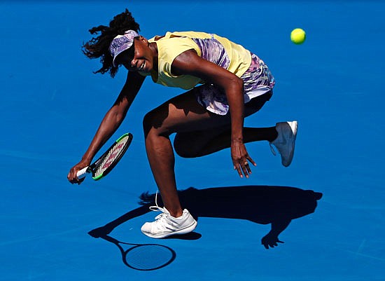 Venus Williams chases down shot by Stefanie Voegele during their second-round singles match today in Melbourne, Australia.