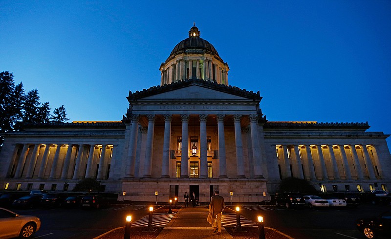 This March 10, 2016, file photo, shows the Legislative Building at dusk at the Capitol in Olympia, Wash. The conversation about paid family leave in Washington state is being revived a decade after passage of a law that was never implemented because lawmakers didn't pay for it. Now lawmakers from the state where companies like Microsoft and Amazon give their employees the benefit are introducing bills for a broader law that would give workers more paid time off, a higher weekly benefit and a steady funding stream. The first hearing on one of the bills happens Thursday, Jan. 19, 2017.
