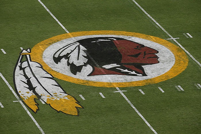 The Washington Redskins logo is seen on the field before an NFL football preseason game against the New England Patriots in Landover, Md. The Supreme Court is expressing doubts about a law that bars the government from registering trademarks that are deemed offensive. 