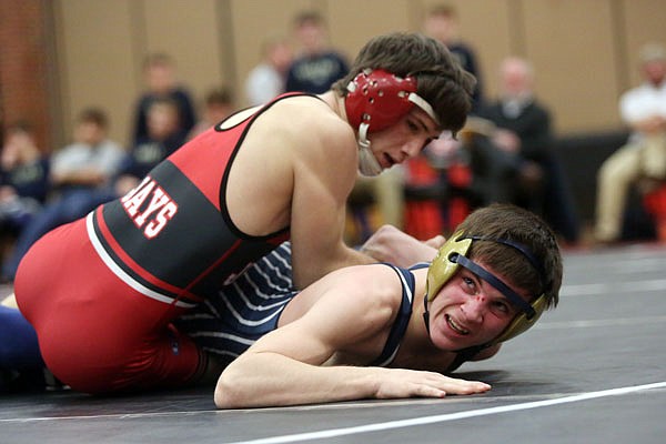 Charlie Kusick of the Jays tries to keep Zack Carr of Helias on the mat during their 126-pound match Wednesday night at Fleming Fieldhouse.