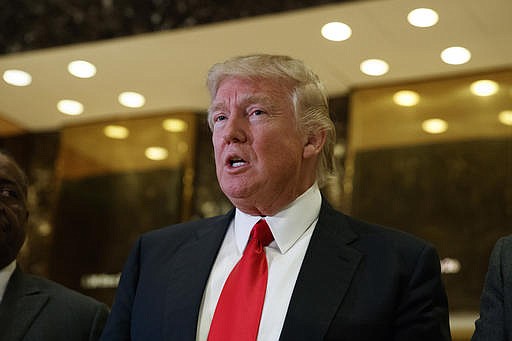 In this Jan. 13, 2017 file photo, President-elect Donald Trump speaks with reporters in the lobby of Trump Tower in New York. Trump's decision not to appoint any Latinos to his cabinet is drawing fierce criticism from Hispanics who called it a major setback given that Latinos are now the nation's largest minority group.