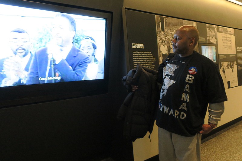 In this photo taken Jan. 16, 2016,  Charles Phillips, 58, looks at an exhibit at the Smithsonian National Museum of African-American History in Washington. Phillips and other black visitors said they came to the museum on the Martin Luther King Jr. federal holiday to mark the end of President Barack Obama's historic term. Obama, the nation's first black president, leaves office on Friday. 