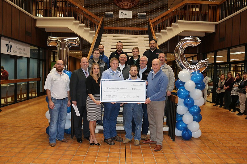 Two Texarkana College students studying Construction Technology recently received $1,000 scholarships from Red River Lumber. Recipients Justin Sheets and Cory Pitts will also have the opportunity for internships with the company. Front row from left to right: Casey Boyette, TC Construction Technology instructor; James Henry Russell, TC President; Katie Andrus, TC Foundation executive director; Justin Sheets, TC Construction Technology Student; Cory Pitts, TC Construction Technology Student; Mike Craven, owner of Red River Lumber Company. Also pictured are construction contractors, local home builders and Red River Lumber Company employees.
