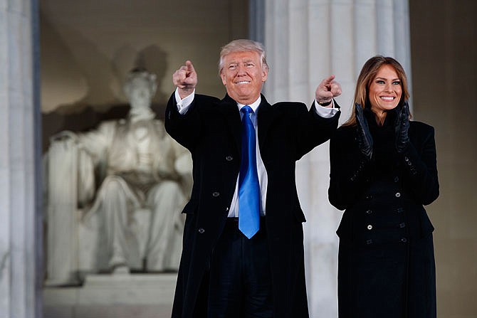 President-elect Donald Trump, left, and his wife Melania Trump arrive to the "Make America Great Again Welcome Concert" Thursday at the Lincoln Memorial in Washington. 