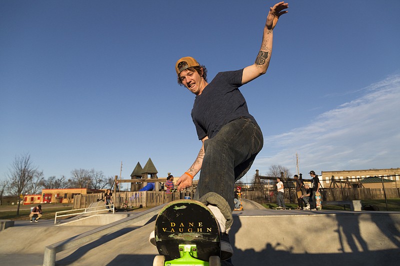 Brandon Walls skateboards Friday at the skate park in downtown Texarkana. Skaters gathered Friday to pick up cigarette butts, skate and grill hamburgers. 