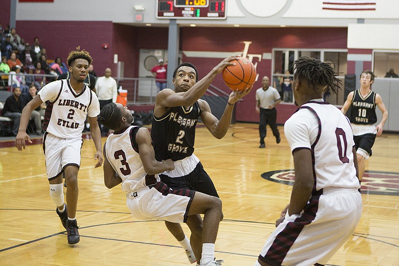 PG 66, L-E 54. Pleasant Grove's Stephen Austin bowls over Liberty-Eylau's Anthony Cunningham on Friday at the Rader Dome. 