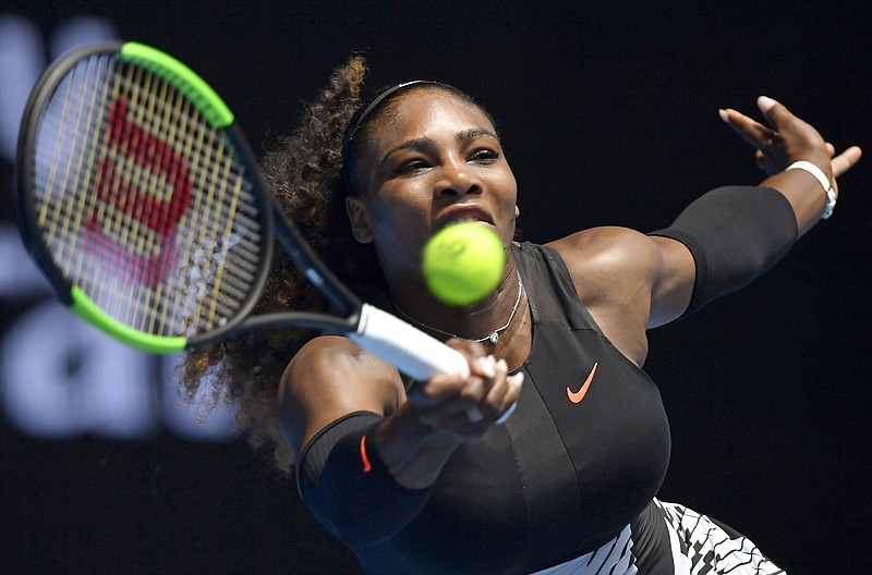 Serena Williams makes a forehand return Friday at the Australian Open tennis championships in Melbourne, Australia.