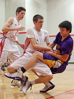 Colin Bernskoetter of Calvary Lutheran fights for the basketball with a Stoutland player during Friday night's game at Calvary.